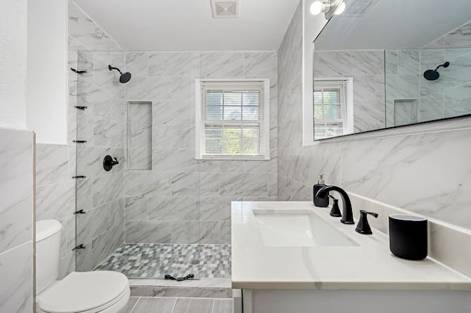 Step into sophistication with this fully remodeled master bathroom. Discover the grandeur of a spacious walk-in shower enclosed by a sleek glass wall.