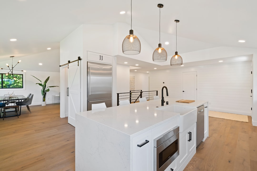 modern design open kitchen that features a spacious island with white marble countertops